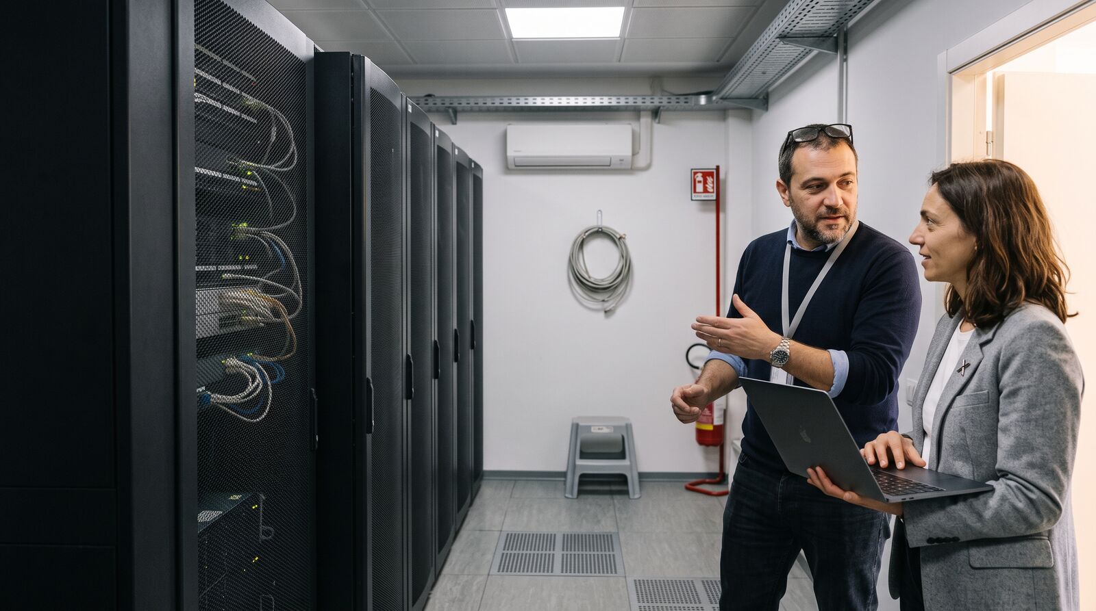 VERIAX consultant and technician connecting systems in a server room.